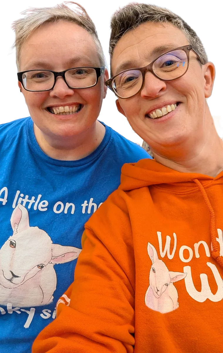 Rhoda and Becca, smiling, in their Wonky T-shirt and hoodie